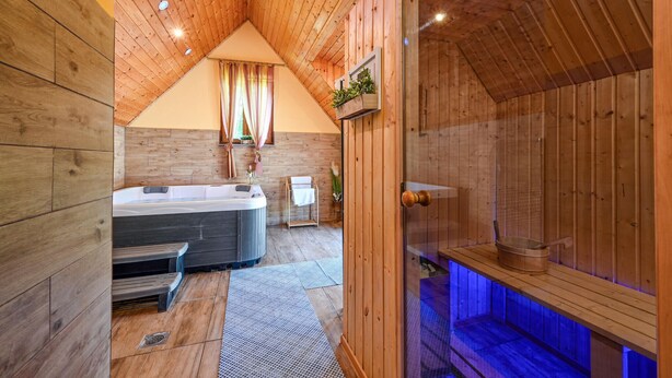 A wooden cabin with a hot tub, a shower area, and a small seating area. - Nice home in Rivalno with sauna (Rivalno)