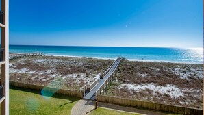 A beach view from a balcony with a wooden walkway leading to the shore. - Gulf front! 3rd floor right on the beach! With free beach service (Navarre)