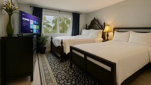A hotel room with two beds, a TV on a desk, a window with curtains, a lamp, and a plant. - Experience Seattle Hot Tub Firepit Backyard BBQ EV2 King Bed (Lynnwood)