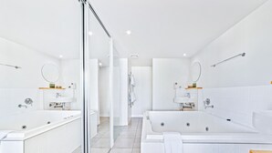 A modern bathroom with two large tubs, a glass shower enclosure, and a wooden vanity. - Sea La Vie - Airlie Beach (Airlie Beach)