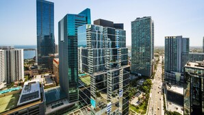 A high-rise urban area with modern skyscrapers, including a building with a visible 'COHABAD' sign. - Miami Downtown City view 3BR Air Hockey &Ping Pong (MIAMI)