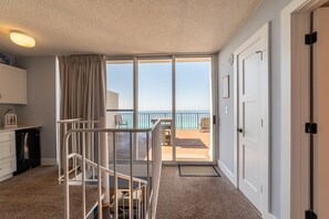 Enjoy a sea view from the balcony, featuring a table and chair.