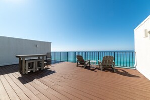 Relax on the deck with a clear view of the ocean, perfect for dining or unwinding.