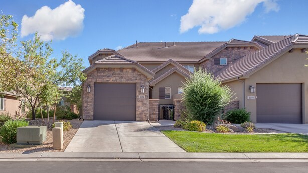 A two-story residential house with a stone facade, two garage doors, and a well-maintained lawn. - 4194 Coral Ridge Resort, Dog Friendly, BBQ grill, Private Hot Tub, Community Pool (Washington)