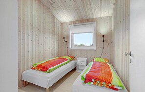 A small, cozy bedroom with two single beds, a window, and a white wardrobe. - 2 bedroom lovely home in Skjern (Skjern)