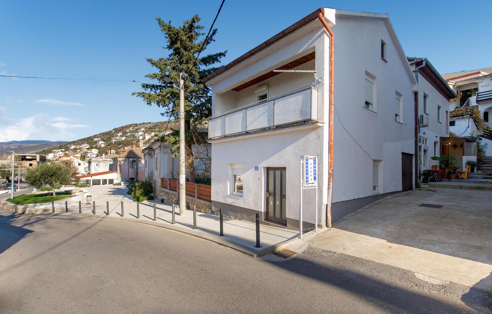 A two-story building with a balcony on the upper floor.