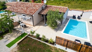 A residential property with a swimming pool, a covered patio, and a fenced garden area. - Stunning home in Galizana (Galizana)