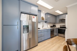Enjoy cooking in this well-equipped kitchen with a refrigerator, oven, and dining area.