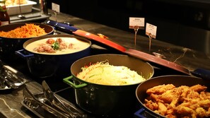 A buffet with various dishes including a pot of soup, a bowl of noodles, and a dish of fried chicken. - Holiday Inn Zhengzhou High Tech Zone by IHG (Zhengzhou)
