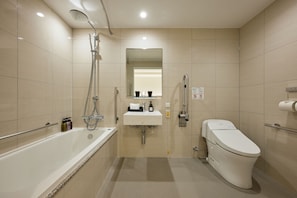 Enjoy a relaxing soak in the bathtub, complete with a showerhead and toiletries at hand.