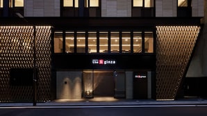 A modern hotel facade with a geometric pattern, illuminated signage, and a clear entrance. - the b ginza (Tokyo)