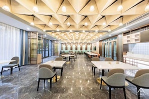 A conference room with a geometric ceiling design, marble flooring, and modern furniture. - Atour Hotel Hengyang West Jiefang Road (Hengyang)