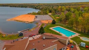 A residential area with a swimming pool, a dock, and a large open field. - Luxury Vacation home in the Poconos close to the lake and community pool.  (Albrightsville)