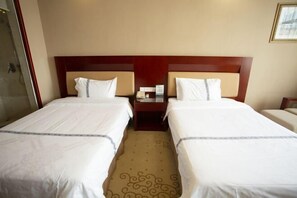 A hotel room with two beds, a wooden headboard, a small bedside table with a lamp, and a shower area. - Runying Hotel (Tianchang)