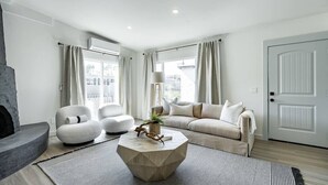 A modern living room with a sofa, two armchairs, a coffee table, and a fireplace. - The Rosemont II - 2BR La Jolla Gem Near the Beach (San Diego)