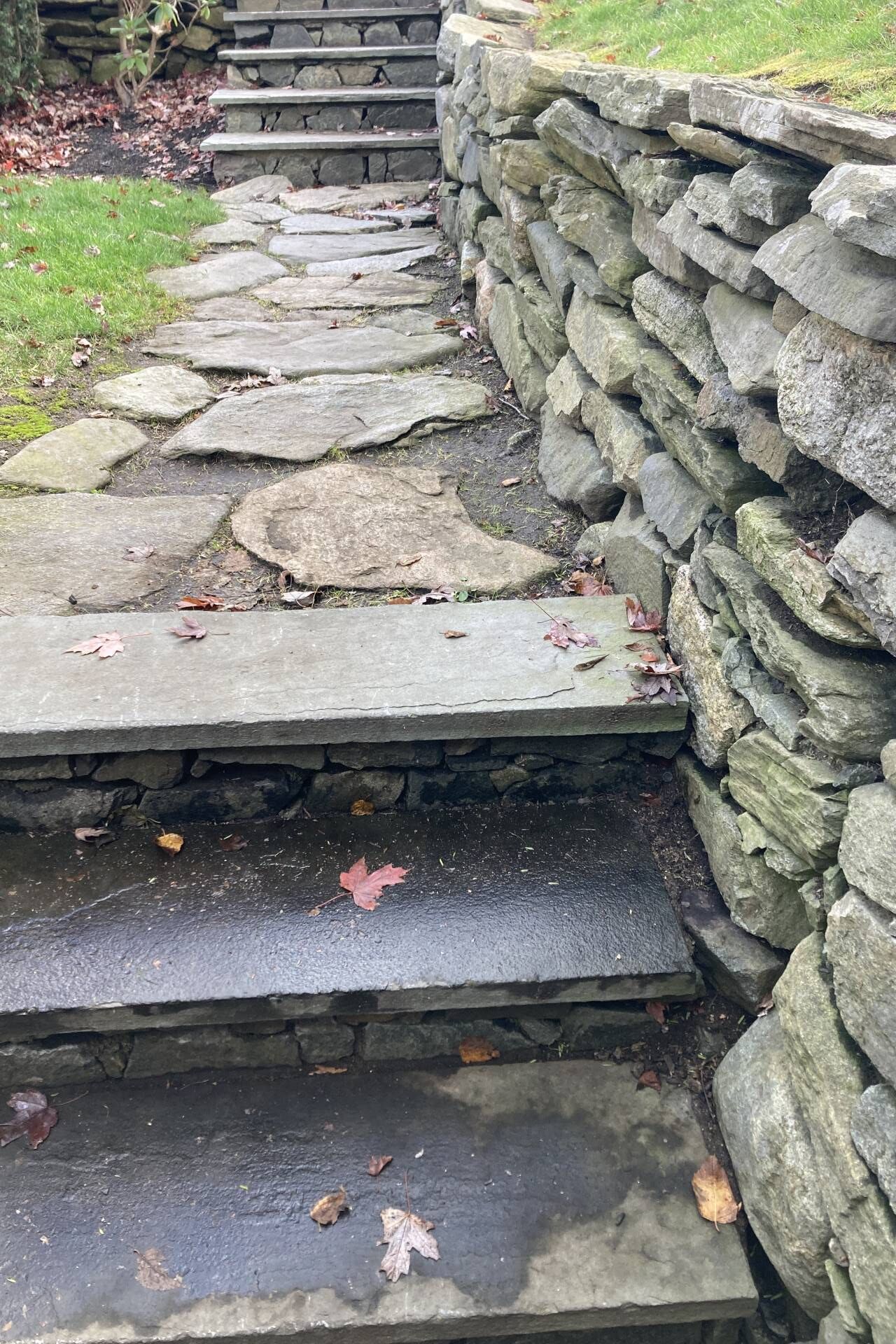 Uma escadaria de pedra que leva a um muro de pedra.