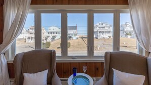 A room with two chairs facing a large window overlooking a residential area. - Blue Star (Salisbury)
