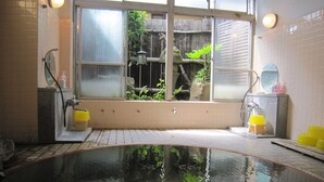A room with a large window, a bathtub, and a small sink. - Yudanaka Onsen Shimaya (Yamanouchi)