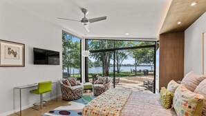 A bedroom with a large window, a bed, a desk, and a chair. - Adults-Only Lake Peninsula Cottage w/ Pool, Pickleball & Sunset Views (Malakoff)