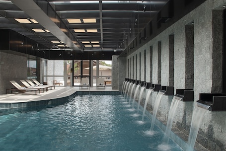 Indoor pool, open 9:00 AM to 10:00 PM, pool loungers. Exclusive Gramado Hotel & Spa by Gramado Parks