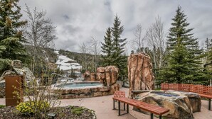 A park with benches, a hot tub, and a rocky landscape. - Springs 8806 (Keystone)
