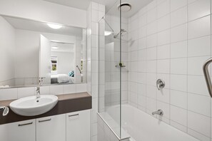 Combined shower/bathtub, hair dryer, towels, soap - King One Bedroom Executive Apartment (Burwood)