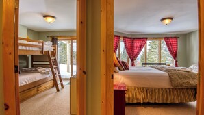 A room with bunk beds, a ladder, a bed with a canopy, and a window with curtains. - Rock Pond Condo 79 | Saddleback, Ski-in/out (Sandy River Plantation)