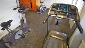 A gym with cardio equipment including treadmills and stationary bikes. - Radisson Hotel Paris Le Bourget (Bonneuil-en-France)