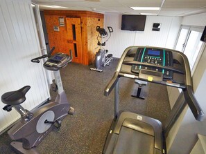 A gym with cardio equipment including treadmills and stationary bikes. - Radisson Hotel Paris Le Bourget (Bonneuil-en-France)