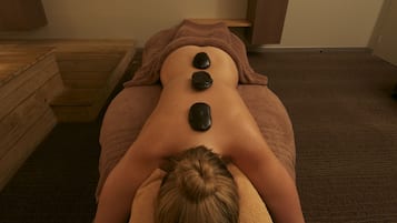 Experience a rejuvenating massage on a comfortable table, surrounded by soothing ambiance.