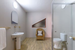 A bathroom with a sink, mirror, chair, and toilet. - Africlassic Rivonia by BON Hotels (Sandton)