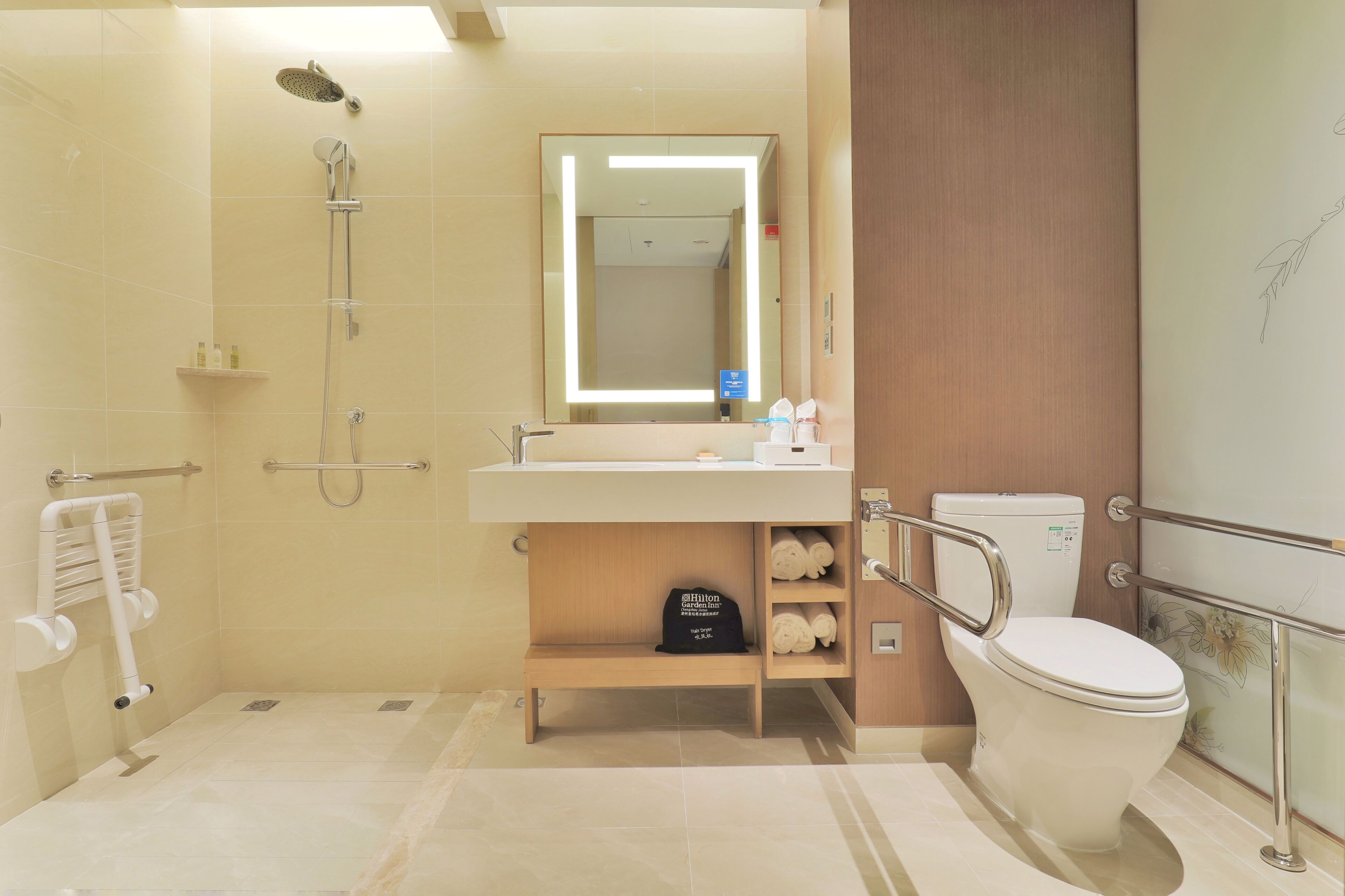 A modern bathroom with a shower, toilet, and sink.