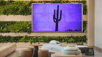 Relax in style with a flat-screen TV, lush green gardens, and comfortable seating options.