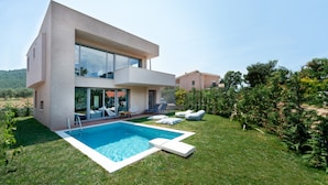 A modern two-story house with a swimming pool, outdoor seating, and a well-maintained lawn. - SunBlue Villa Modern Private Pool (thasos)