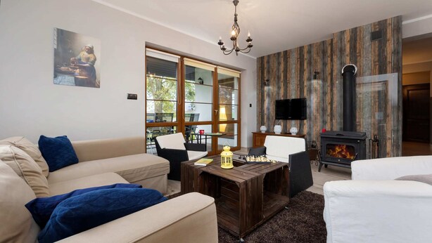 A living room with a sofa, a coffee table, and a fireplace.