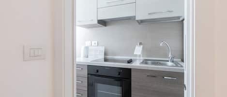 A modern kitchen with a built-in oven, a sink, and a countertop.
