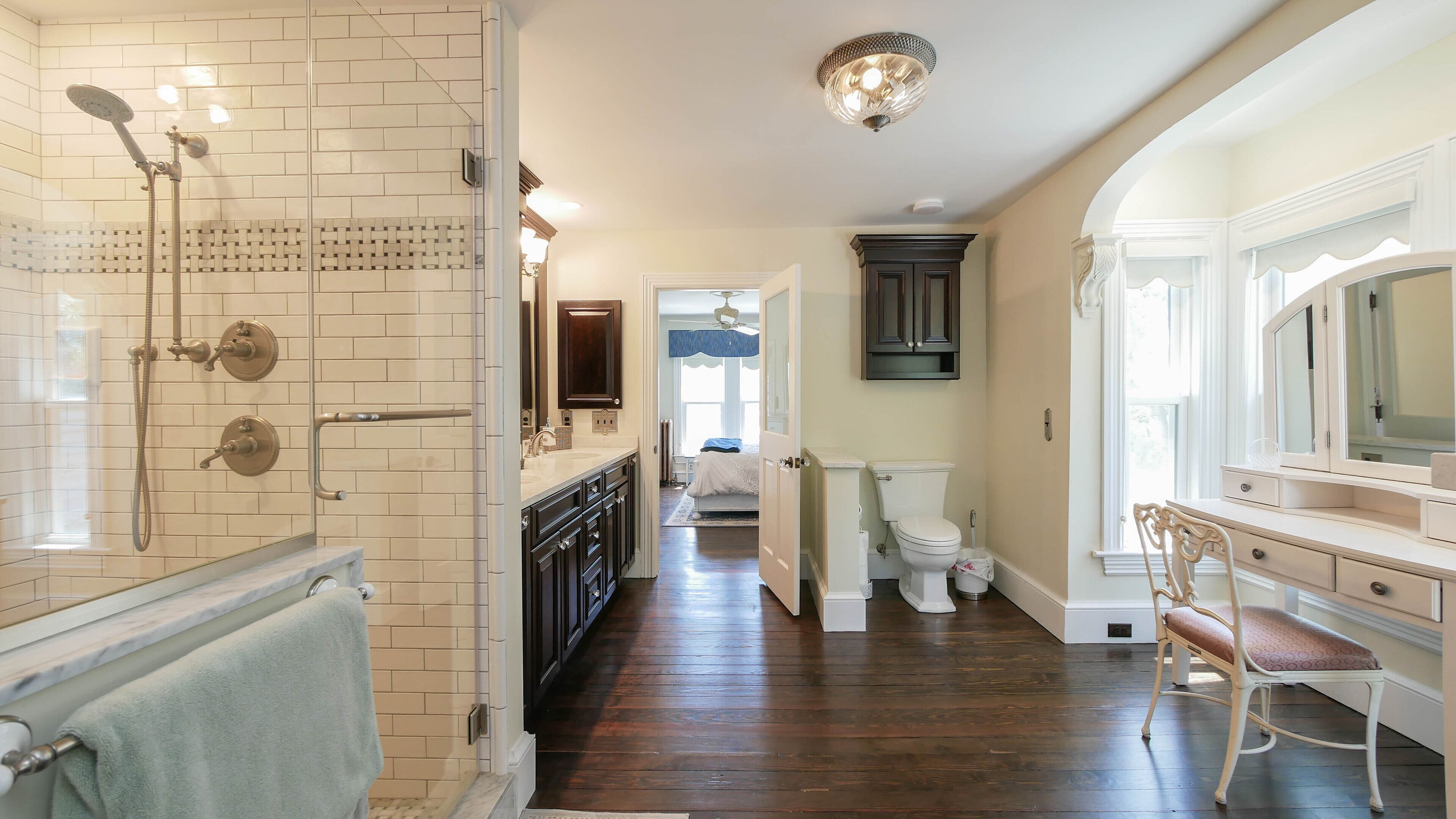 A bathroom with a shower, toilet, and vanity.