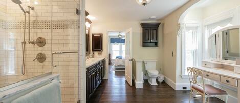 A bathroom with a shower, toilet, and vanity.