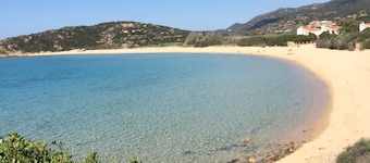 The house under the tower surrounded by greenery and fragrant Mediterranean scrub.