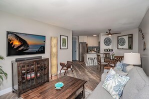 A living room with a TV, wooden coffee table, and a sofa.