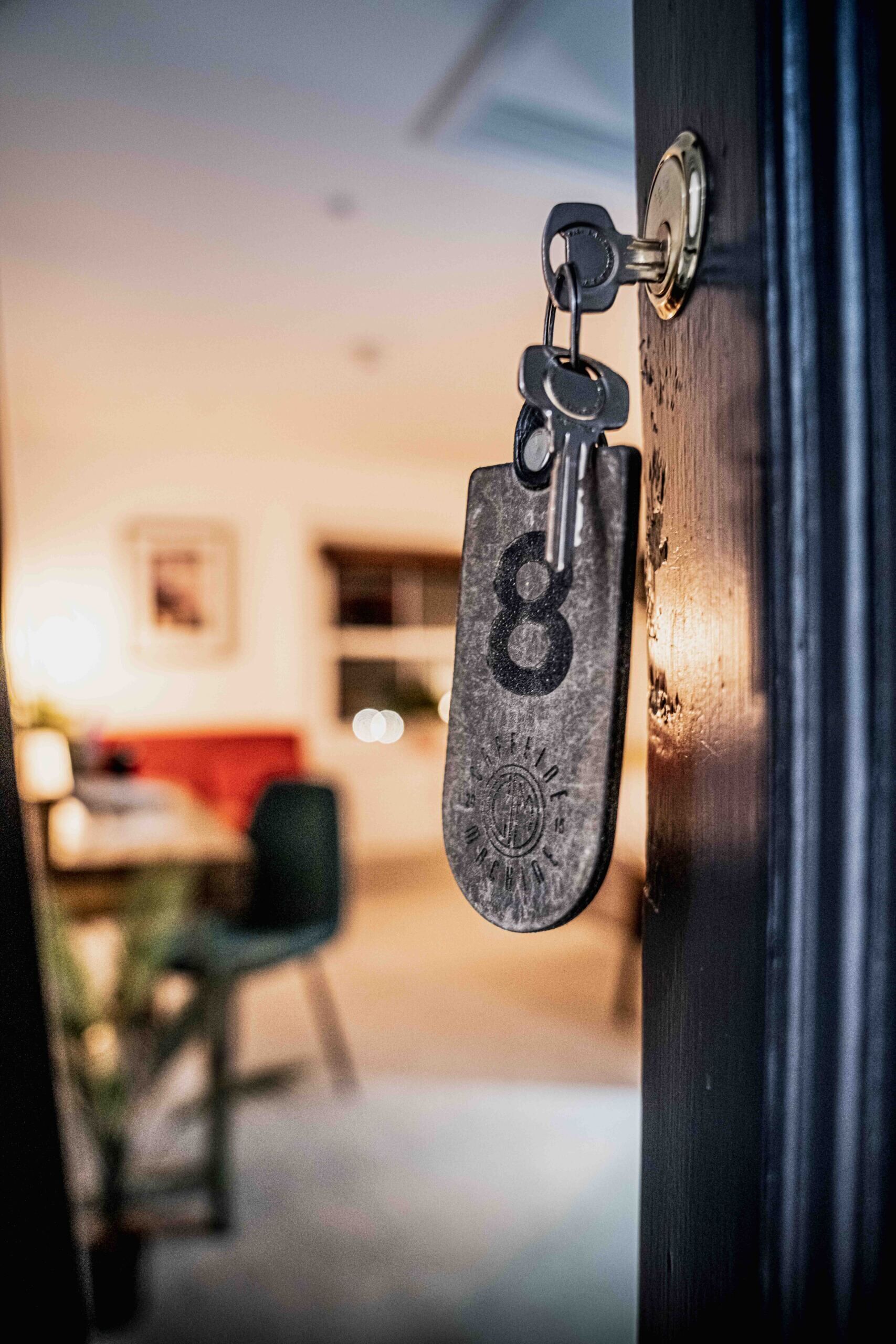 A door with a keychain and a key.
