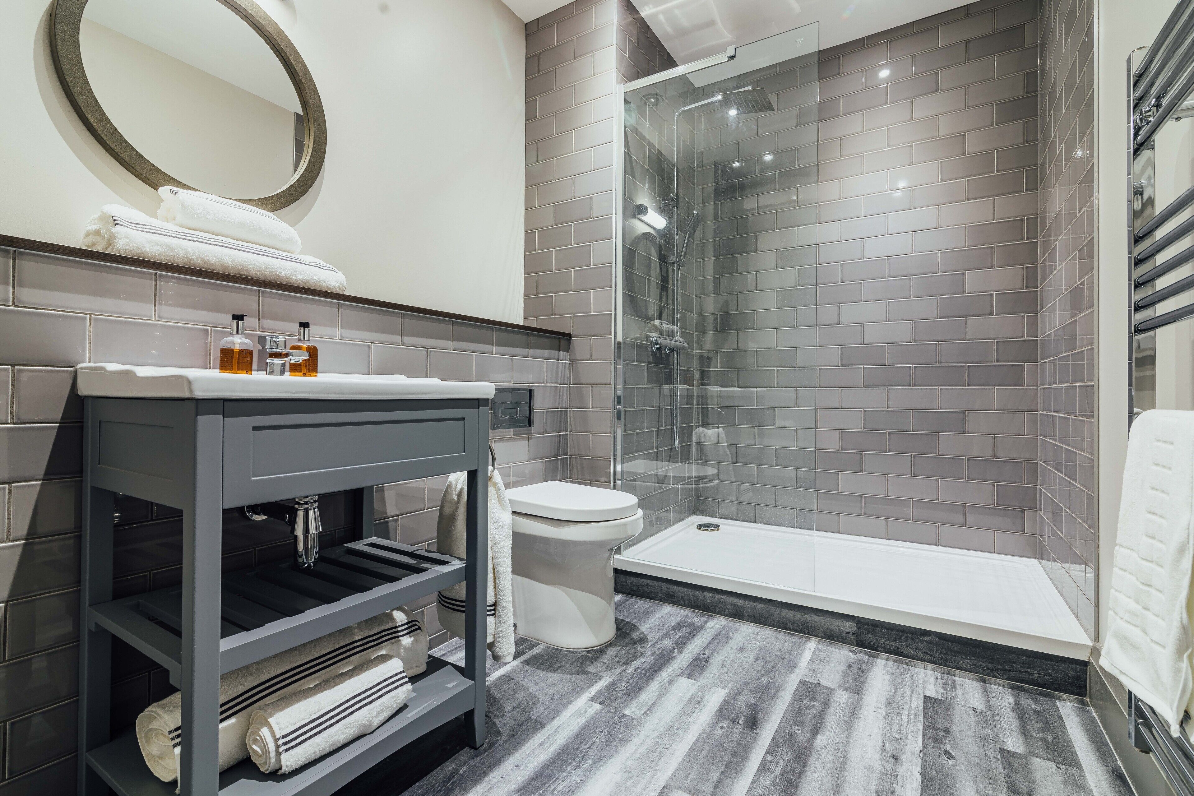 shower, rainfall showerhead, hair dryer, towels