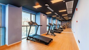 A modern gym with treadmills, stationary bikes, and a mirrored wall. - Holiday Inn Express Shanghai Baoshan Baoyang by IHG (Shanghai)