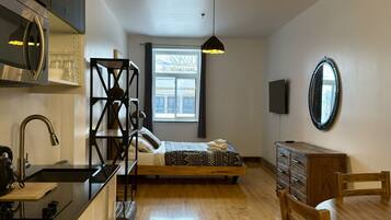 1 bedroom, desk, iron/ironing board, travel crib