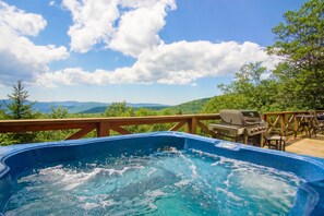 A hot tub on a wooden deck with a view of mountains and trees. - Top Property In Snowshoe 8 Br Nwr Rd 11 Luxury Home (Snowshoe)
