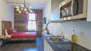 A modern kitchen with a built-in microwave and stainless steel appliances.