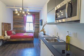 A modern kitchen with a built-in microwave and stainless steel appliances.