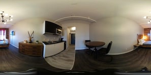 A panoramic view of a modern interior with a kitchen, dining area, and a bedroom. - Loft douillet au centre-ville ! (Québec)