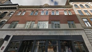A multi-story building with a brick facade and large windows. - Intimate loft in the heart of the city (Québec)