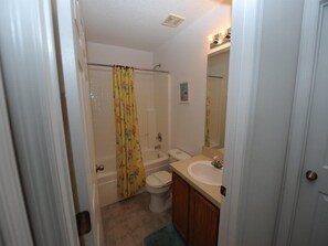 A bathroom with a shower, toilet, and sink. - Lakeview Villa (Clermont)